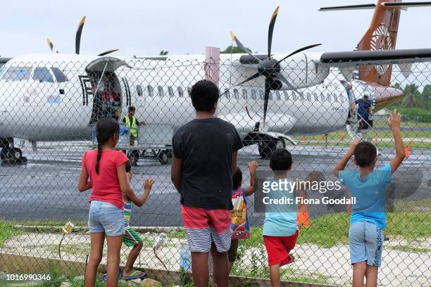 People gather at the airport three times a week to welcome and farewell passengers from Suva, Fiji on August 15, 2018 in Funafuti, Tuvalu. The siren...