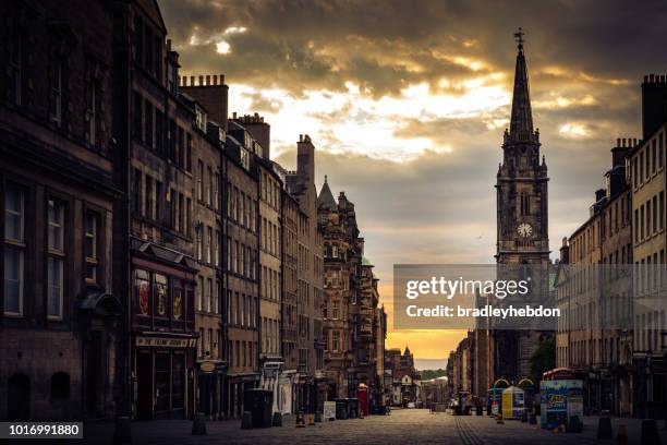 tron kirk clock tower at dawn along the royal mile in edinburgh, scotland - edinburgh old town stock pictures, royalty-free photos & images