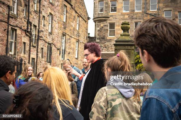 a tour guide leads a group of fans on a harry potter tour in edinburgh - celebration of harry potter stock pictures, royalty-free photos & images