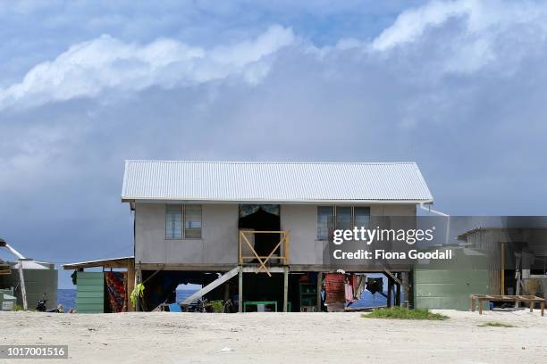 House stands on reclaimed land next to the ocean on August 15, 2018 in Funafuti, Tuvalu. 'Borrow pits' created by the US military to build an...