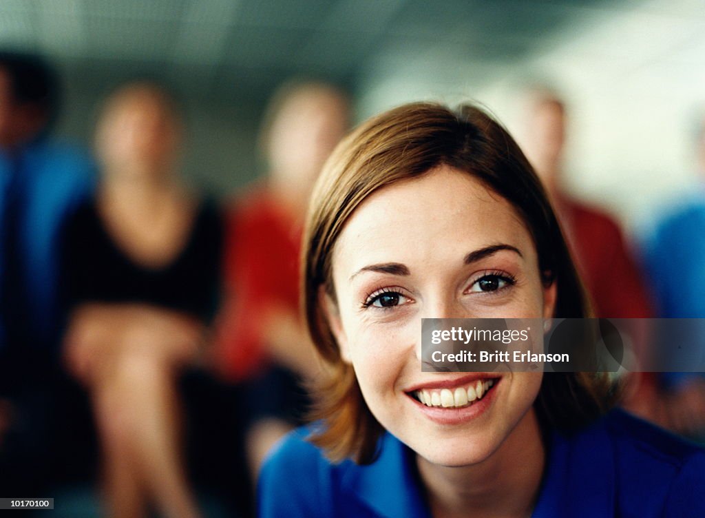 SMILING PROFESSIONAL WOMAN IN OFFICE
