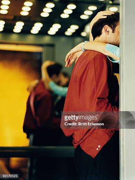 man and woman kissing in elevator at work - couple lust stock pictures, royalty-free photos & images
