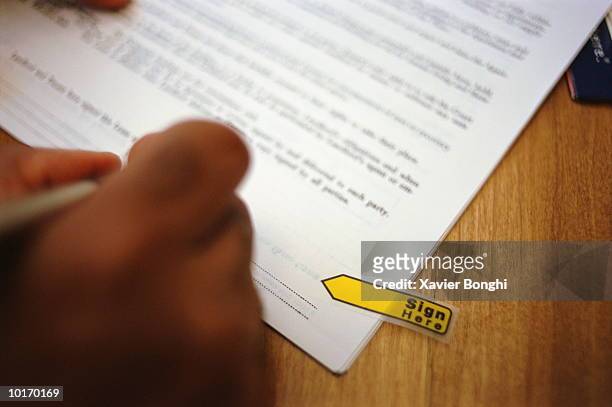 african american man signing document - contract stock pictures, royalty-free photos & images