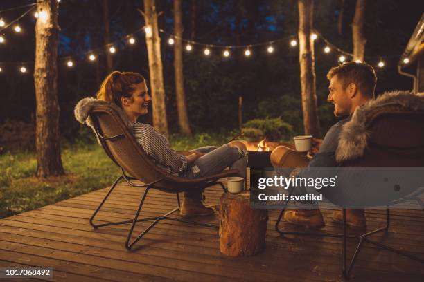 couple on porch - string light stock pictures, royalty-free photos & images