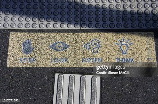 road safety sign on the sidewalk for the stop, look, listen, think procedure - pedestrian safety stock pictures, royalty-free photos & images