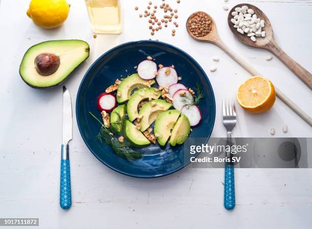 avocado salad with radish and walnut - radijs stockfoto's en -beelden