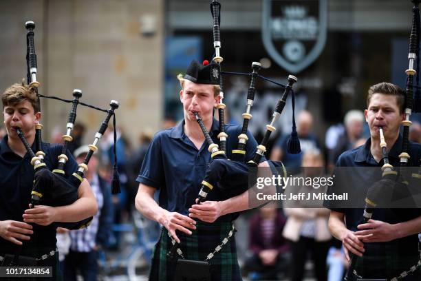 Scots College Pipes and Drums from Sydney, Australia play in Buchanan street during the Piping Live Glasgow International Piping Festival on August...