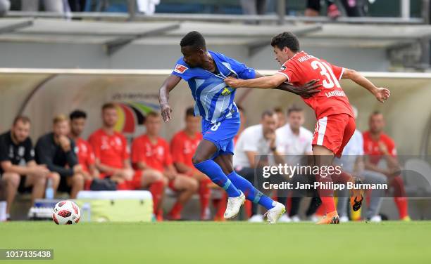 Salomon Kalou of Hertha BSC and Niklas Landgraf of Hallescher FC during the game between Hertha BSC and Hallescher FC at the Amateurstadion on august...