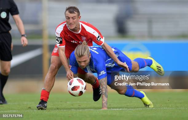 Daniel Bohl of Hallescher FC and Alexander Esswein of Hertha BSC compete for the ball during the game between Hertha BSC and Hallescher FC at the...