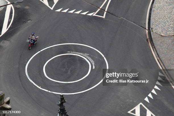 high angle view of a motorcycle crossing roundabout - kreisverkehr stock-fotos und bilder