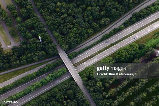 aerial view of highway intersection, in forest, in the netherlands - interstate stockfoto's en -beelden