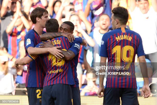 Barcelona's Brazilian midfielder Malcom celebrates with teammates after scoring a goal during the 53rd Joan Gamper Trophy friendly football match...