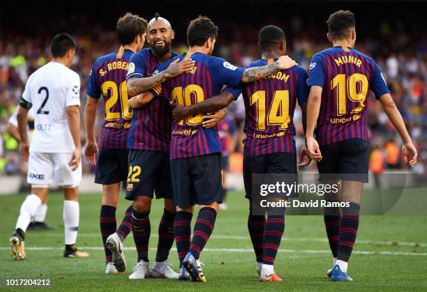 Lionel Messi of Barcelona celebrates with teammates after scoring his team's second goal during the Joan Gamper Trophy between FC Barcelona and Boca...