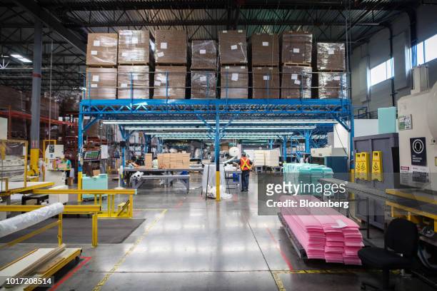 Employees work in the foam packaging and assembly area at the Great Little Box Co. Manufacturing facility in Vancouver, British Columbia, Canada, on...