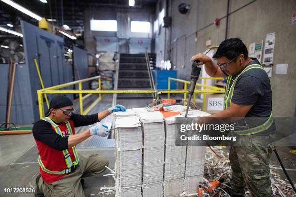 Workers separate pre-cut specialty packaging at the Great Little Box Co. Manufacturing facility in Vancouver, British Columbia, Canada, on Friday,...