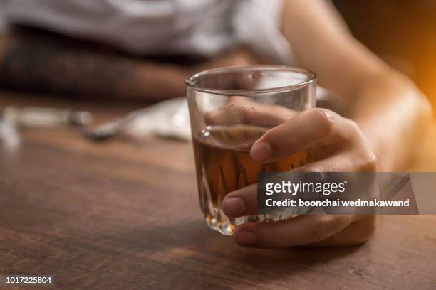 drunk man with a glass of brandy in the pub - alcohol abuse stock pictures, royalty-free photos & images