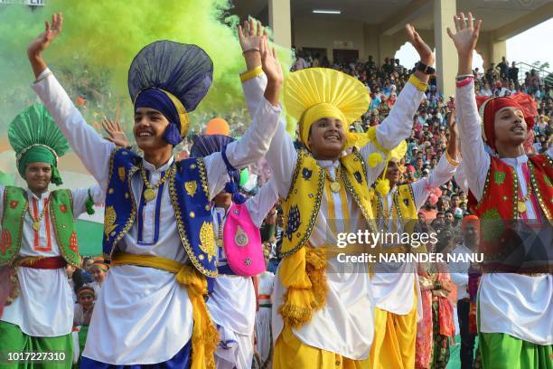 Indian school boys perform the Punjabi dance known as Bhangra during India's 72nd Independence Day celebrations at the India Pakistan Wagah Border...