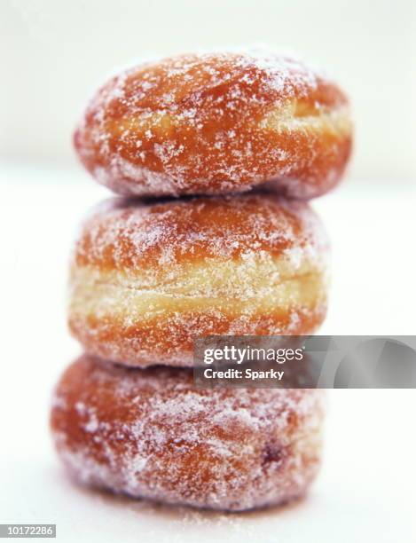 donuts balancing - filled doughnut stock pictures, royalty-free photos & images