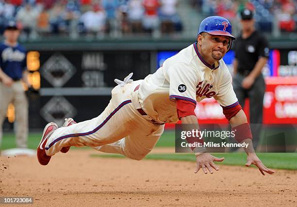 Placido Polanco of the Philadelphia Phillies dives into third base against the San Diego Padres in the tenth inning on June 6, 2010 at Citizens Bank...