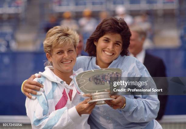 Robin White and Gigi Fernandez both of the USA pose with the trophy after defeating Patty Fendick of the USA and Jill Hetherington of Canada in the...