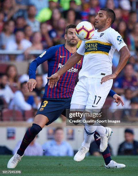 Gerard Pique of Barcelona competes for the ball with Ramon Abila of Boca Juniors during the Joan Gamper Trophy match between FC Barcelona and Boca...