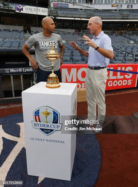 United States Ryder Cup Captian Jim Furyk talks with Aaron Hicks of the New York Yankees prior to a game between the Yankees and the New York Mets at...