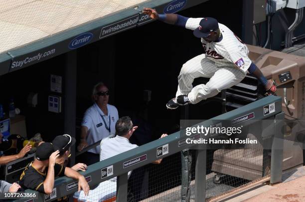 Miguel Sano of the Minnesota Twins jumps into the Pittsburgh Pirates' dugout after catching a foul ball during the sixth inning of the interleague...