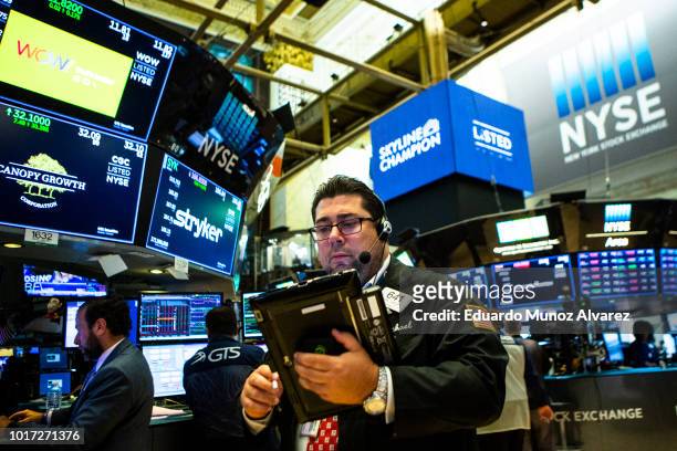 Traders work on the floor of the New York Stock Exchange ahead of the closing bell on August 15, 2018 in New York City. U.S. Stocks fight to avoid a...