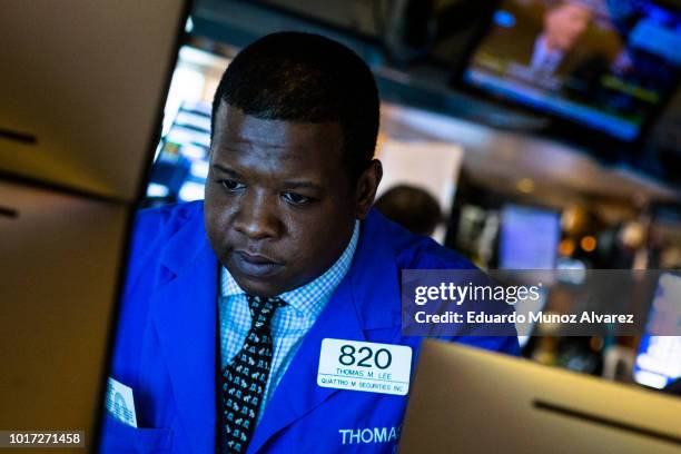 Traders work on the floor of the New York Stock Exchange ahead of the closing bell on August 15, 2018 in New York City. U.S. Stocks fight to avoid a...