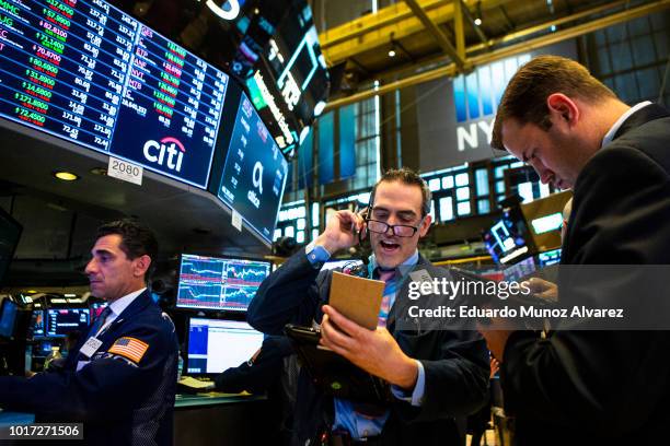 Traders work on the floor of the New York Stock Exchange ahead of the closing bell on August 15, 2018 in New York City. U.S. Stocks fight to avoid a...