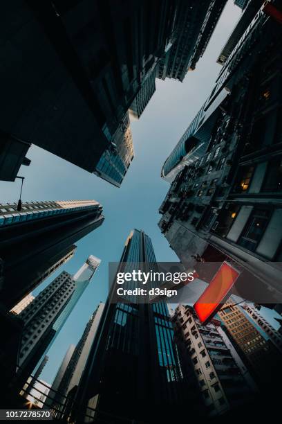 low angle view of compact commercial skyscrapers and commercial sign in downtown hong kong - hong kong advertising stock pictures, royalty-free photos & images