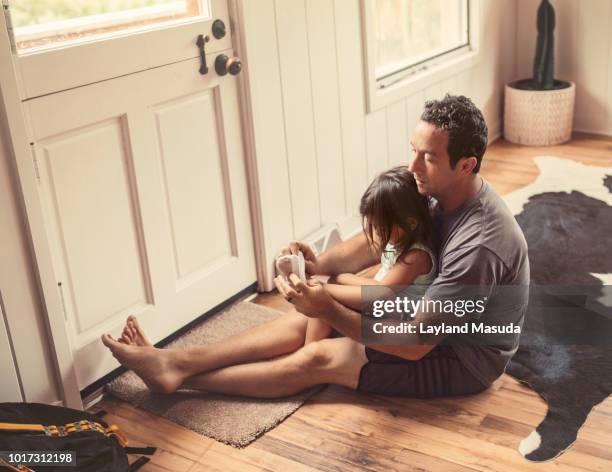 Dad Puts Socks On Toddler