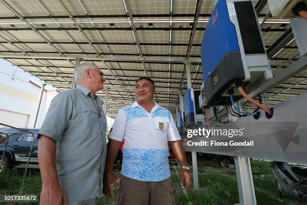 New Zealander Ted Wypych finance manager with Fatonga Talama general manager of the Tuvalu Electricity Company check the readouts on the solar energy...