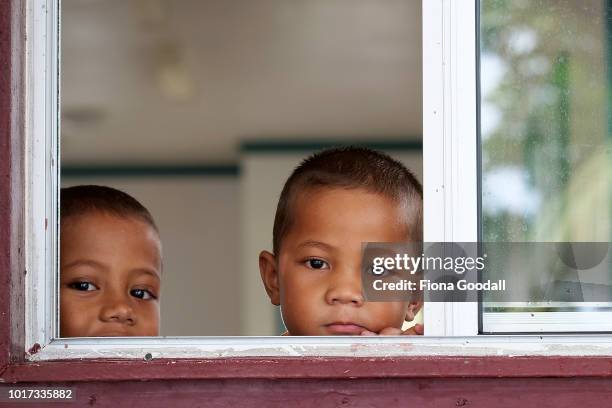 Children look out the church window on August 15, 2018 in Funafuti, Tuvalu. Sunday is a day of family and church. There are many churches on the...