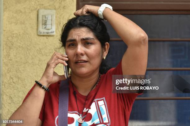 Relative of some of the 19 Colombian victims involved in a bus accident in Ecuador that left 24 dead, talks on her phone during a meeting to organize...