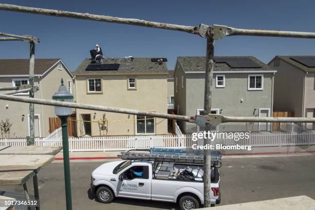 Contractors install SunRun Inc. Solar panels on the roof of a new home at the Westline Homes Willowood Cottages community in Sacramento, California,...