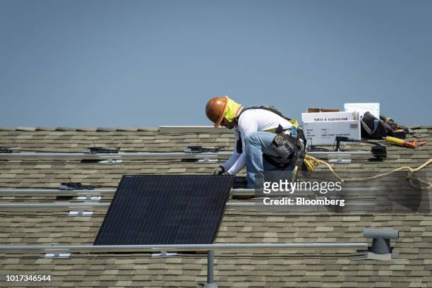 Contractor installs a SunRun Inc. Solar panel on the roof of a new home at the Westline Homes Willowood Cottages community in Sacramento, California,...