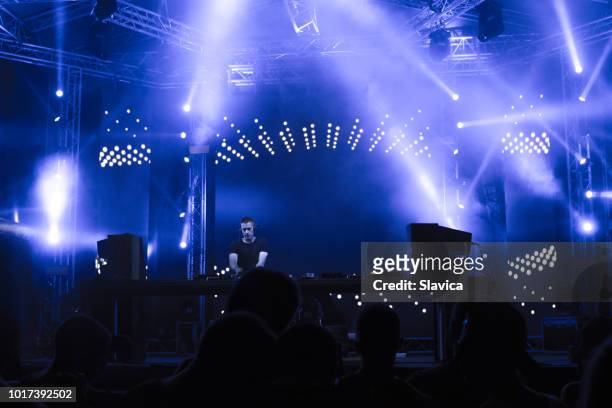 dj playing music on the stage - dj club stock pictures, royalty-free photos & images