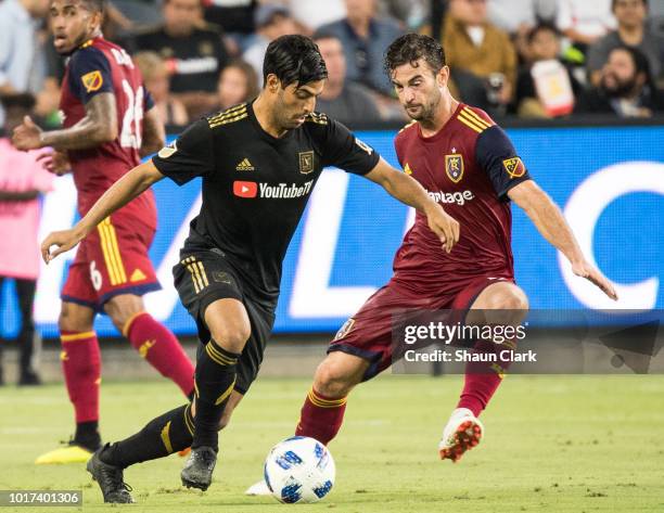 Carlos Vela of Los Angeles FC battles Kyle Beckerman of Real Salt Lake during Los Angeles FC's MLS match against Real Salt Lake at the Banc of...
