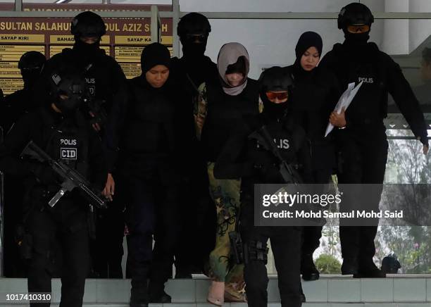 Vietnamese Doan Thi Huong is escorted by police after a court session for her trial at the Shah Alam High Court for murder case of Kim Jong Nam,...