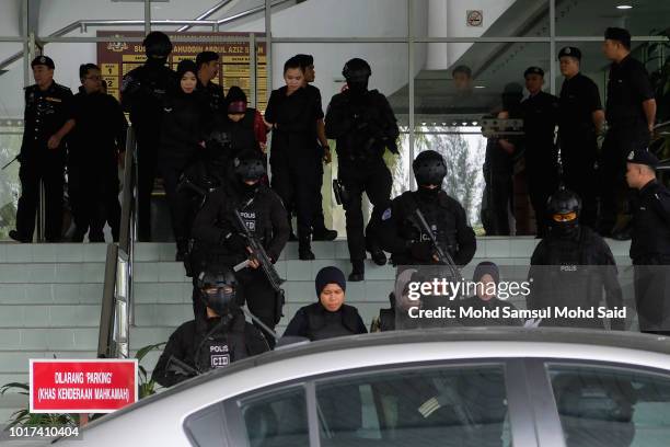 Vietnamese Doan Thi Huong and Indonesia's Siti Aisyah, escorted by police after a court session for their trial at the Shah Alam High Court for...