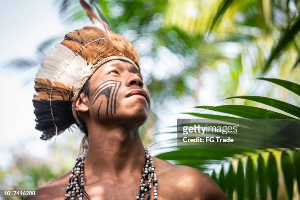 indigenous brazilian young man portrait from guarani ethnicity - brazilian culture stock pictures, royalty-free photos & images