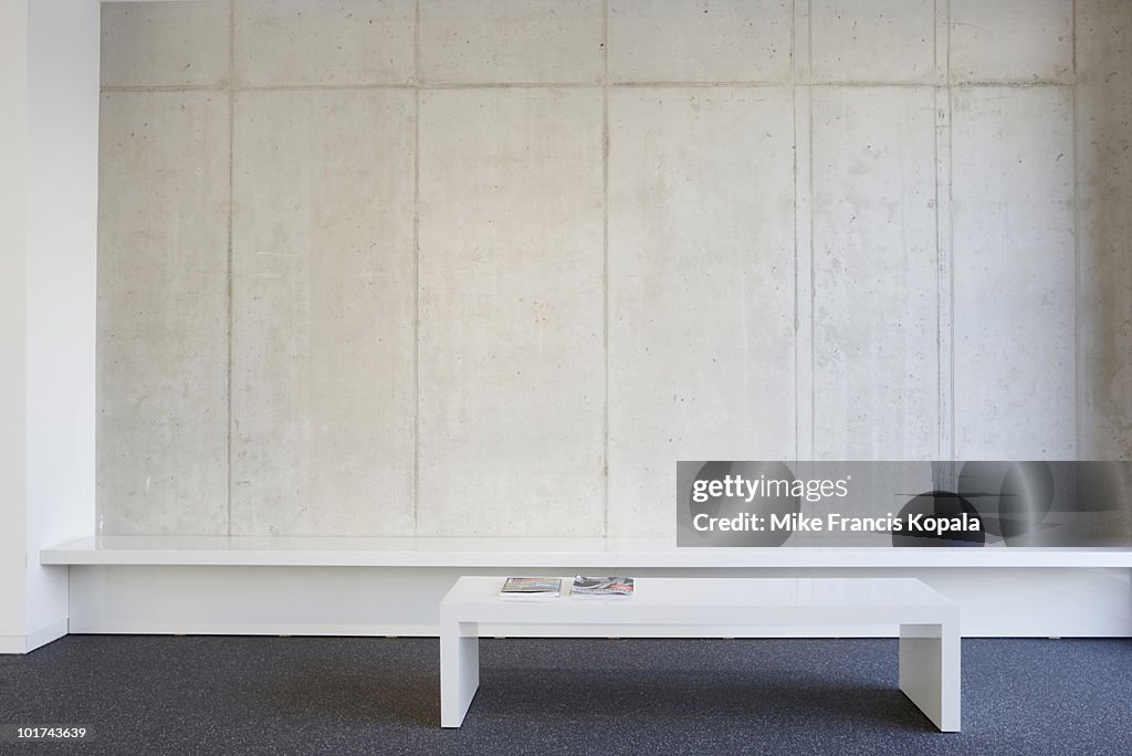 Bench and table in modern office lobby