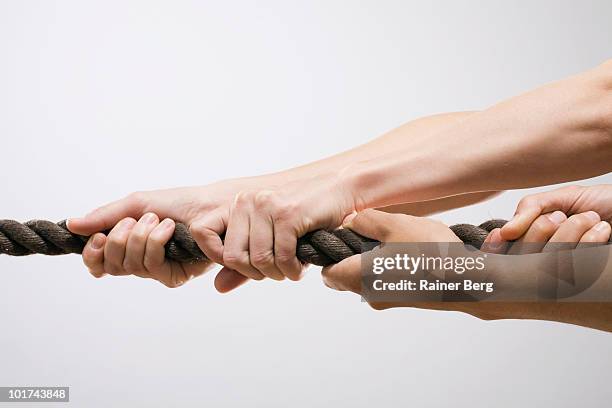 people pulling rope, close-up - tug of war hands stock pictures, royalty-free photos & images