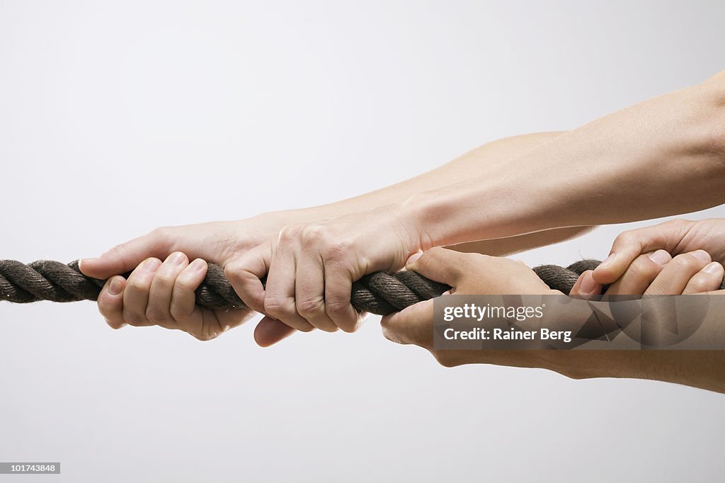 People pulling rope, close-up