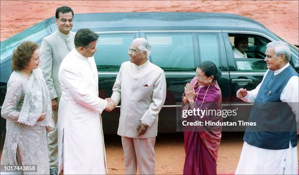 Pakistani President Pervez Musharraf shakes hands with President K.R. Narayanan as their spouses Sehba Musharraf and Usha Narayanan and Prime...