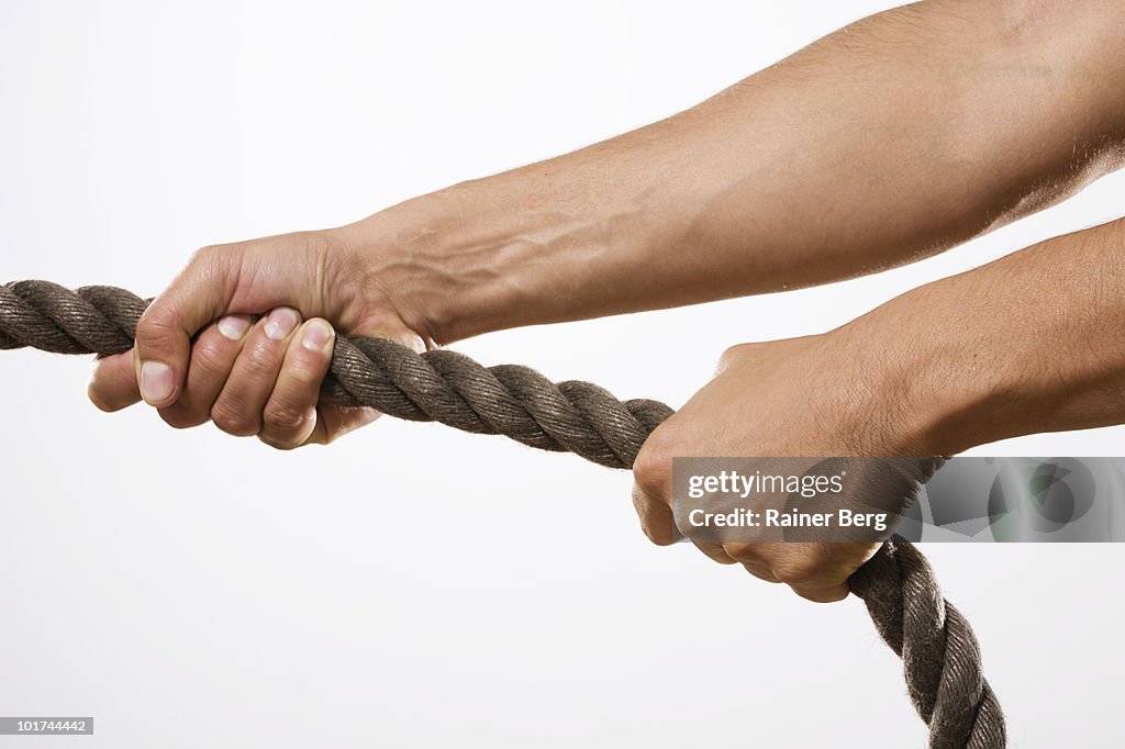 Person pulling rope, close-up