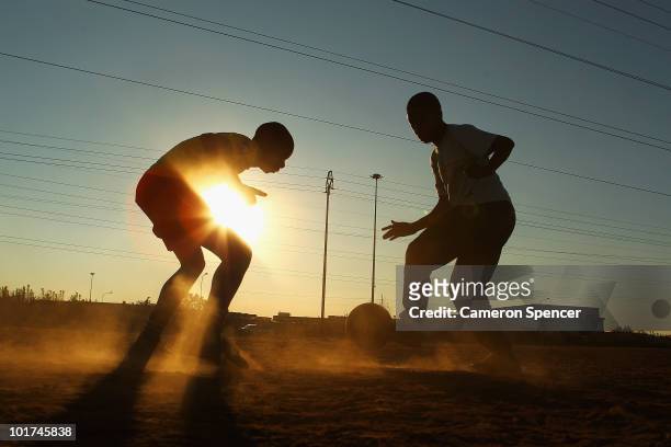 Local children play football on dirt pitches in a Soweto township on June 7, 2010 in Johannesburg, South Africa. The 2010 FIFA World Cup kicks off in...