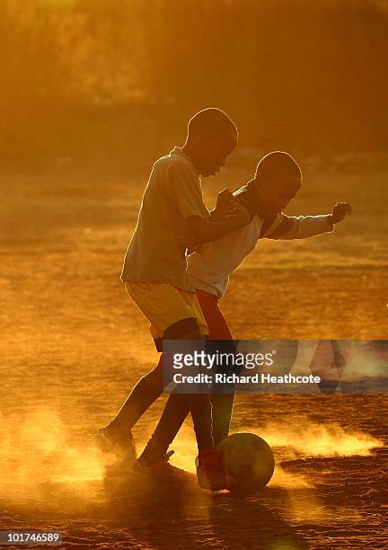 Local children play football on dirt pitches in a Soweto township on June 7, 2010 in Johannesburg, South Africa. The 2010 FIFA World Cup kicks off in...