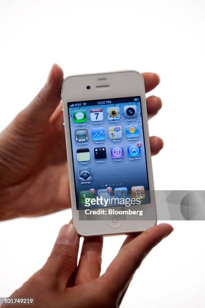 Apple Inc.'s iPhone 4 is held for a photo at the Apple Worldwide Developers Conference in San Francisco, California, U.S., on Monday, June 7, 2010....